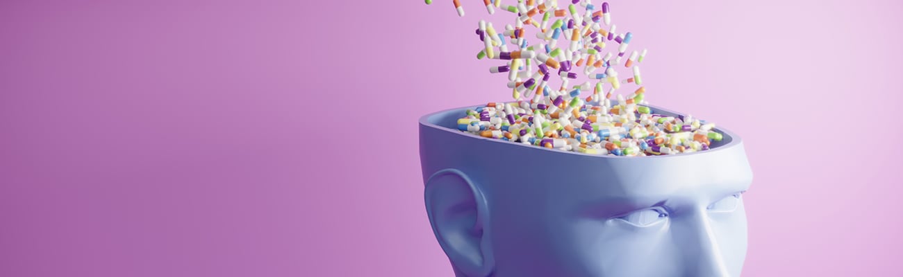 Cartoon of many pills cascading into someone's open head