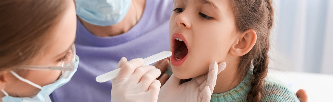 Young girl getting a throat swap checking for strep throat