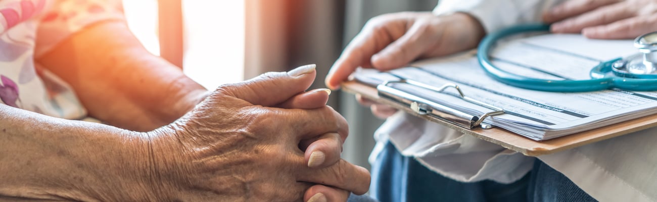 Geriatric doctor consults with an elderly patient in a medical clinic