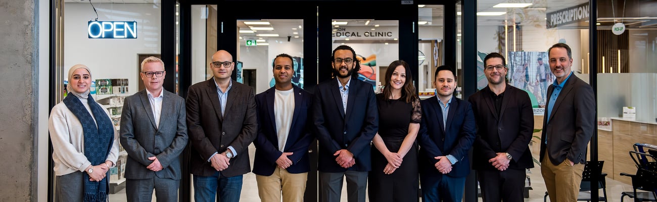Doctors and pharmacists standing in front of the Horizon Pharmacy and Medical clinic in Edmonton