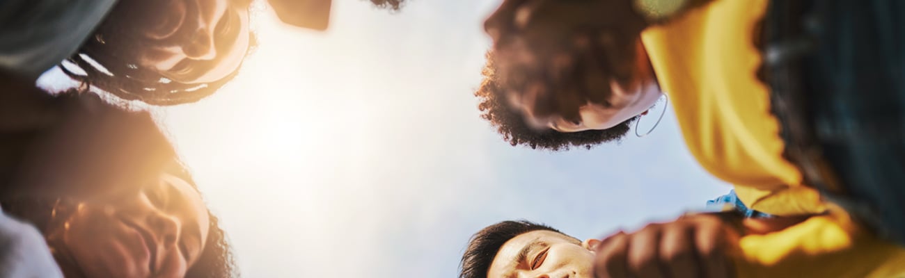 A group of people in a prayer circle