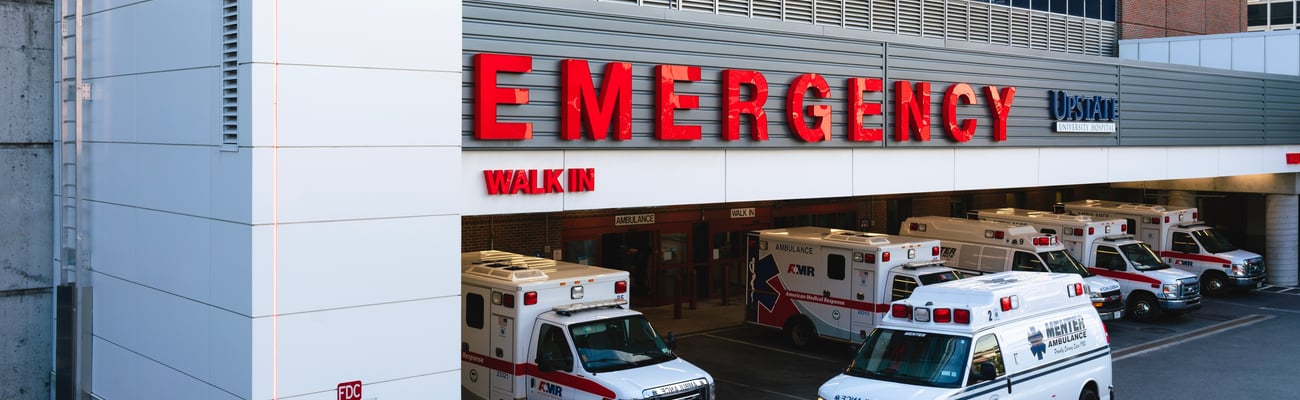 front of hospital with big red "Emergency" sign