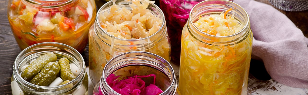 Several jars of colourful fermented foods
