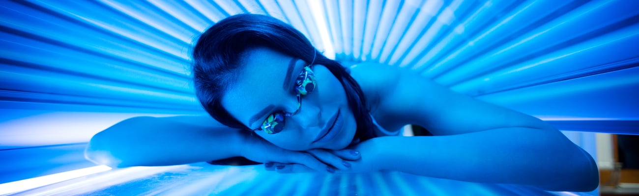 Young woman in a tanning bed