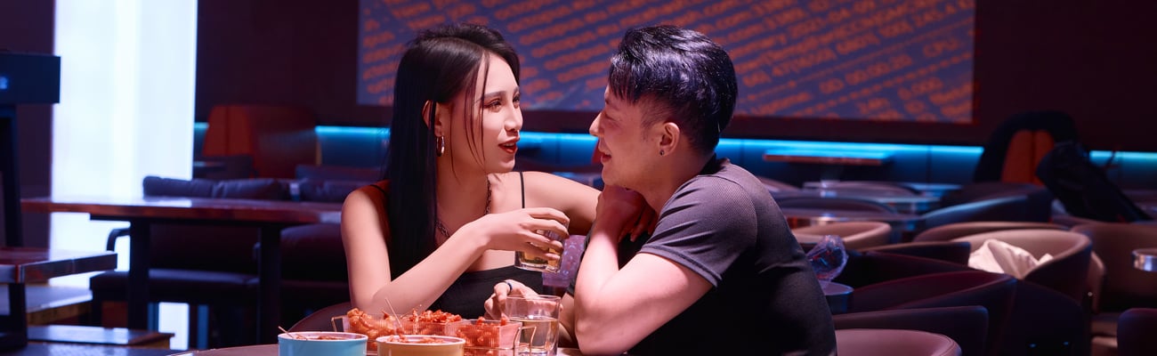 A young couple sitting together at a bar