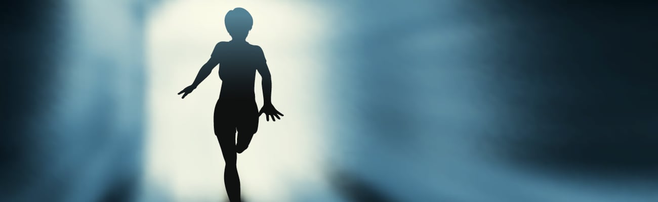 A shadowy figure running towards the light coming through an open door