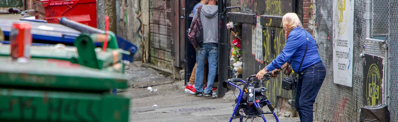 Vancouver, British Columbia/Canada - 09/08/2018: An elderly lady watches on as two young men seek methadone in a back alleyway in Vancouver, British Columbia; Shutterstock ID 1737441326