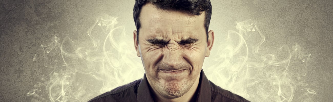 Portrait of Young man thinking too hard .Angry,Stressed man with waving smoke from head.; Shutterstock ID 272440361