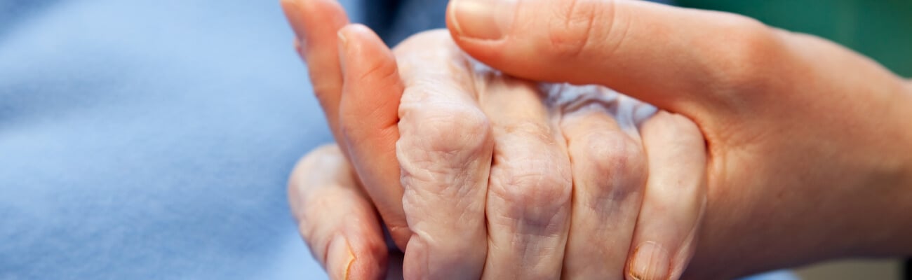 A young hand touches and holds an old wrinkled hand; Shutterstock ID 53417668