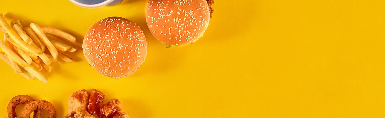 Fast food dish on yellow background. Fast food set fried chicken, meat burger and french fries. Take away fast food.; Shutterstock ID 749423806