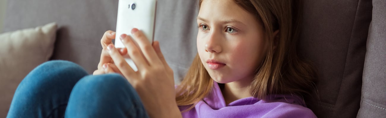 Teen girl on smart phone scrolling social media