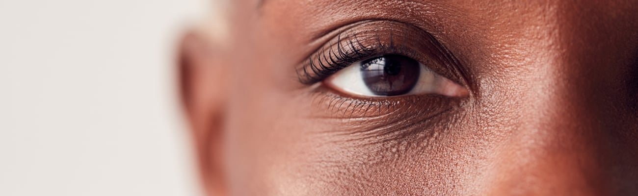 Close up of older Black woman highlighting her eye