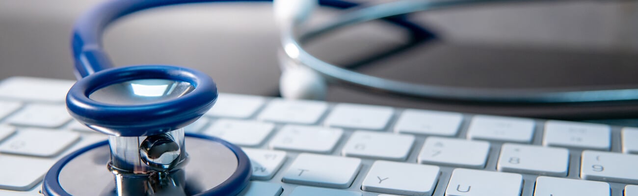 Medical science technology concept. Blue stethoscope on white modern keyboard on doctor desk. Health and wellness background. Global healthcare business. Computer antivirus protection; Shutterstock ID 1222214308