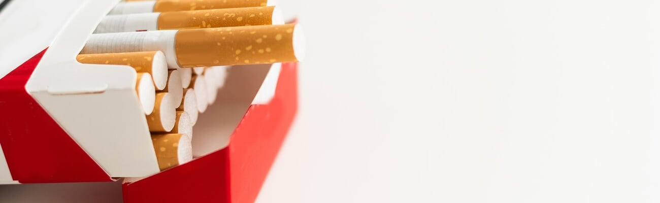 Open pack of cigarettes on a white background; Shutterstock ID 2510814349