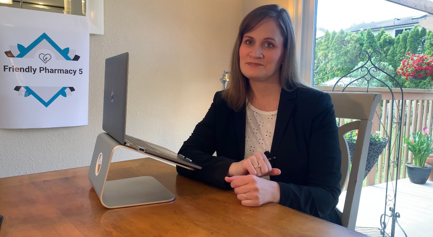 a woman sitting at a table using a laptop