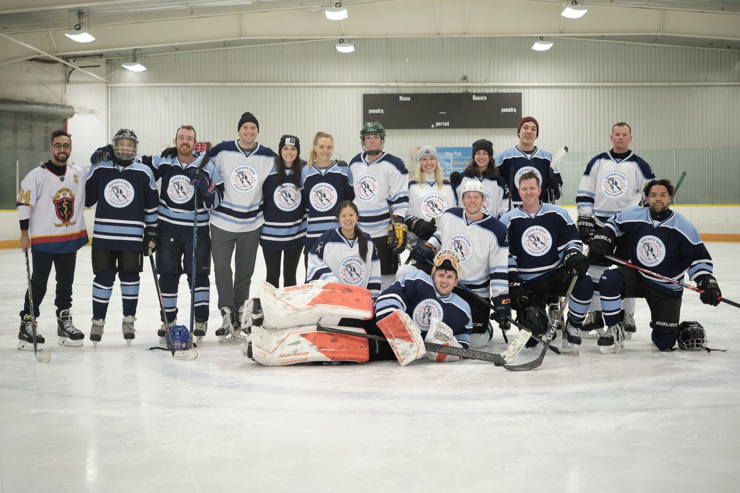 A group of people wearing hockey equipment on ice