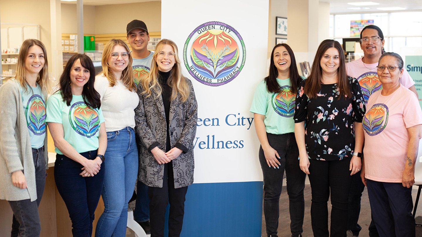 A group of people standing in front of a sign