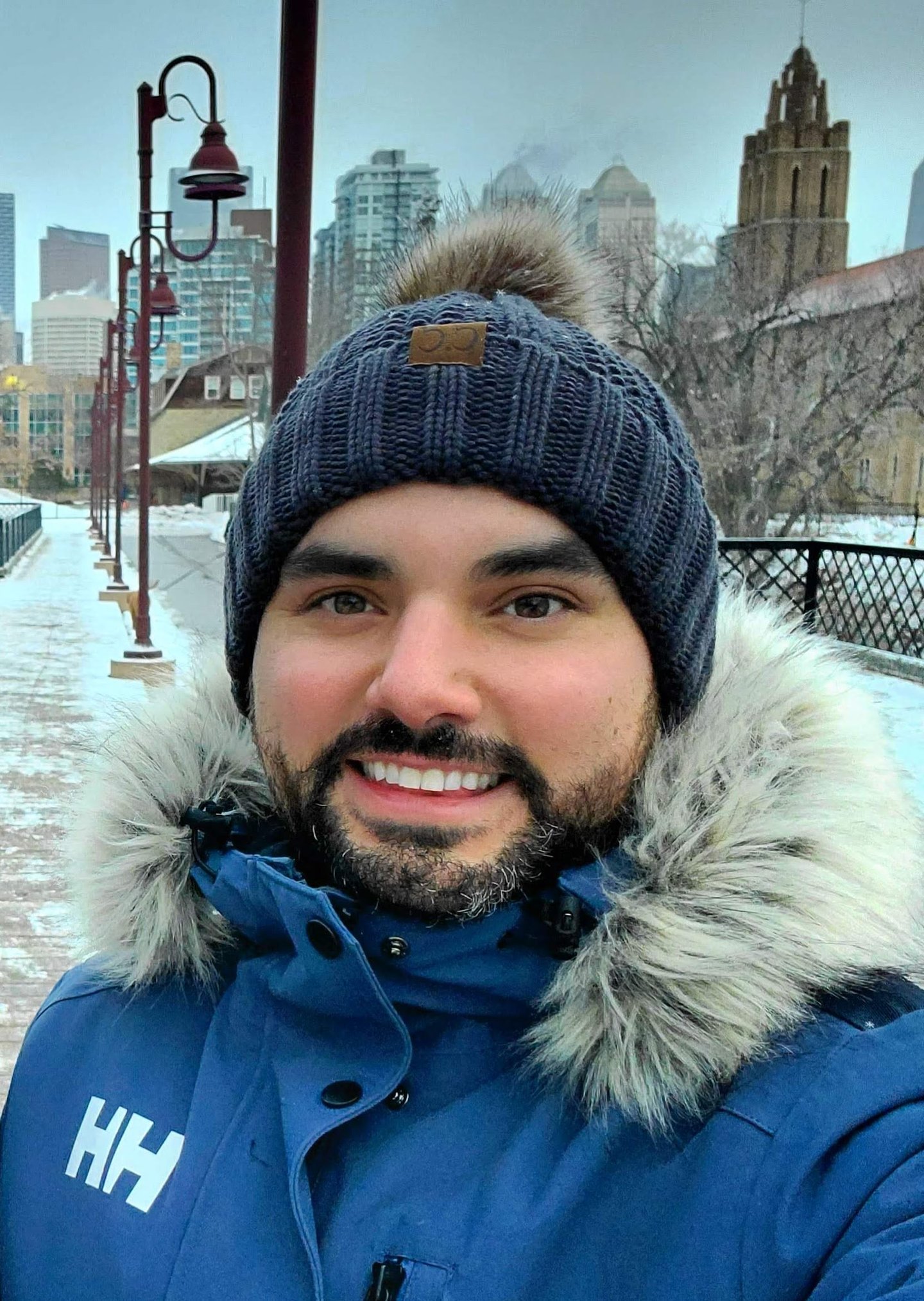 Dr. Brent Young in tuque and parka, urban winter scene in background