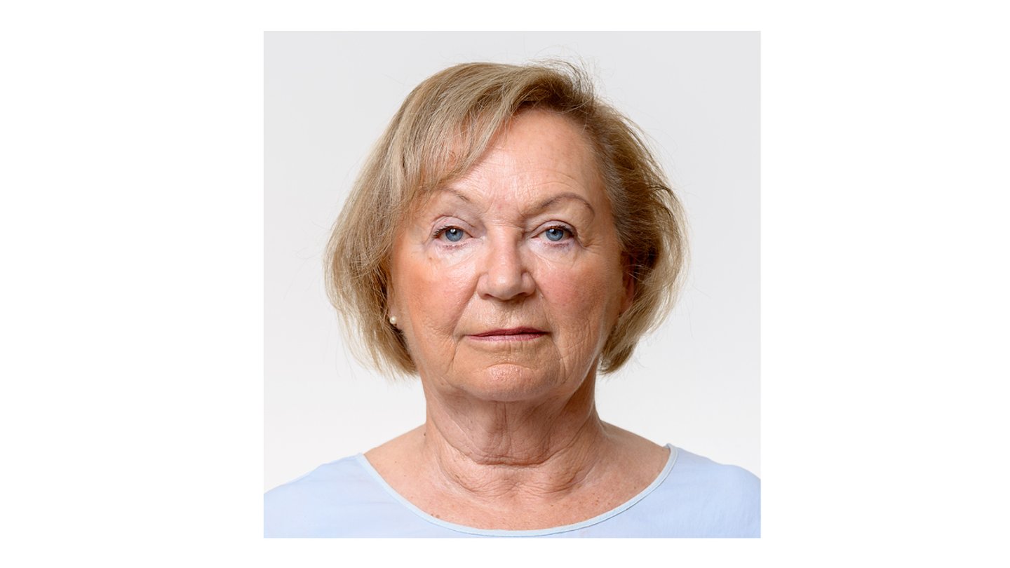 A middle-aged white woman in a light blue shirt