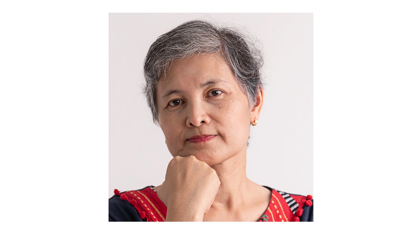 Middle-aged east Asian woman resting her hand on her chin