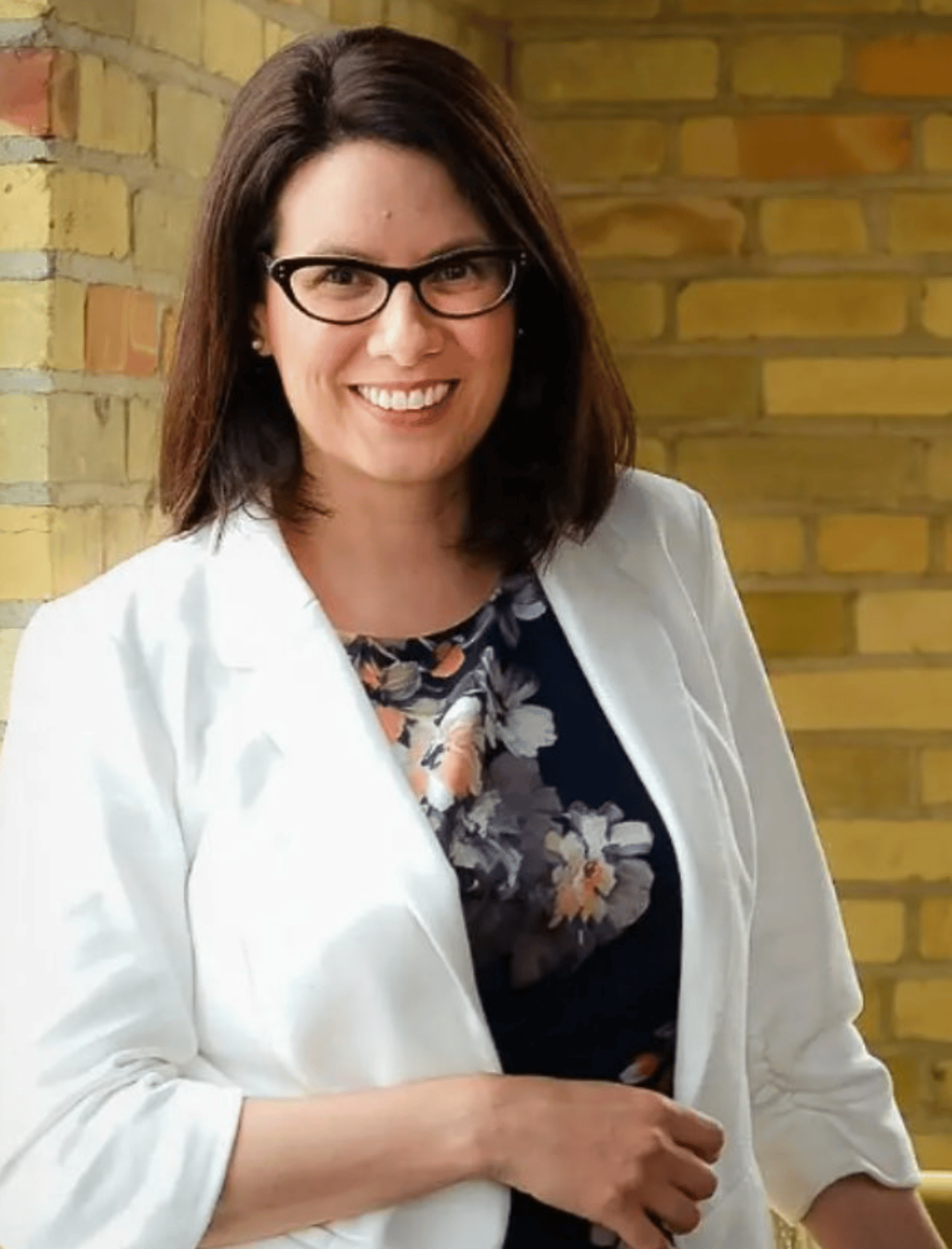 Dr. Debra Evaniuk in a white jacket smiling for a photo