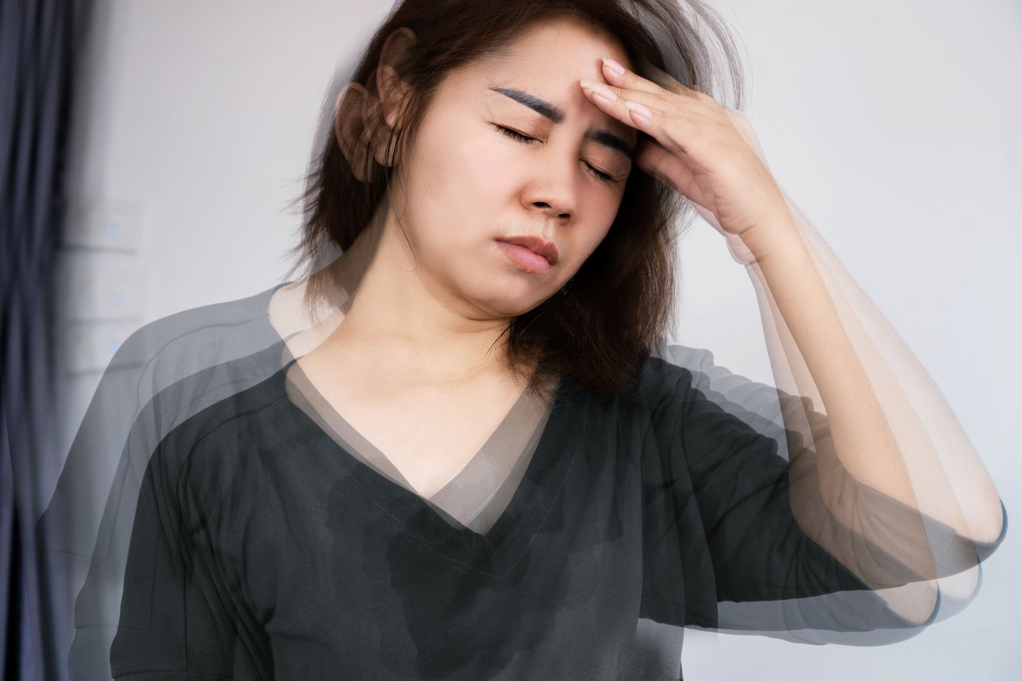 Woman holding her head feeling dizzy
