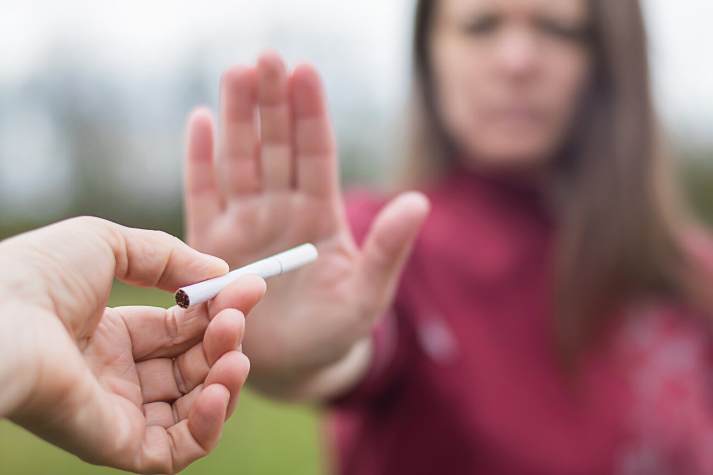 girl refuses a cigarette. woman quits smoking. bad habit.  World No Tobacco Day. human arm is gesturing with refusal. antismoking concept; Shutterstock ID 1737596084