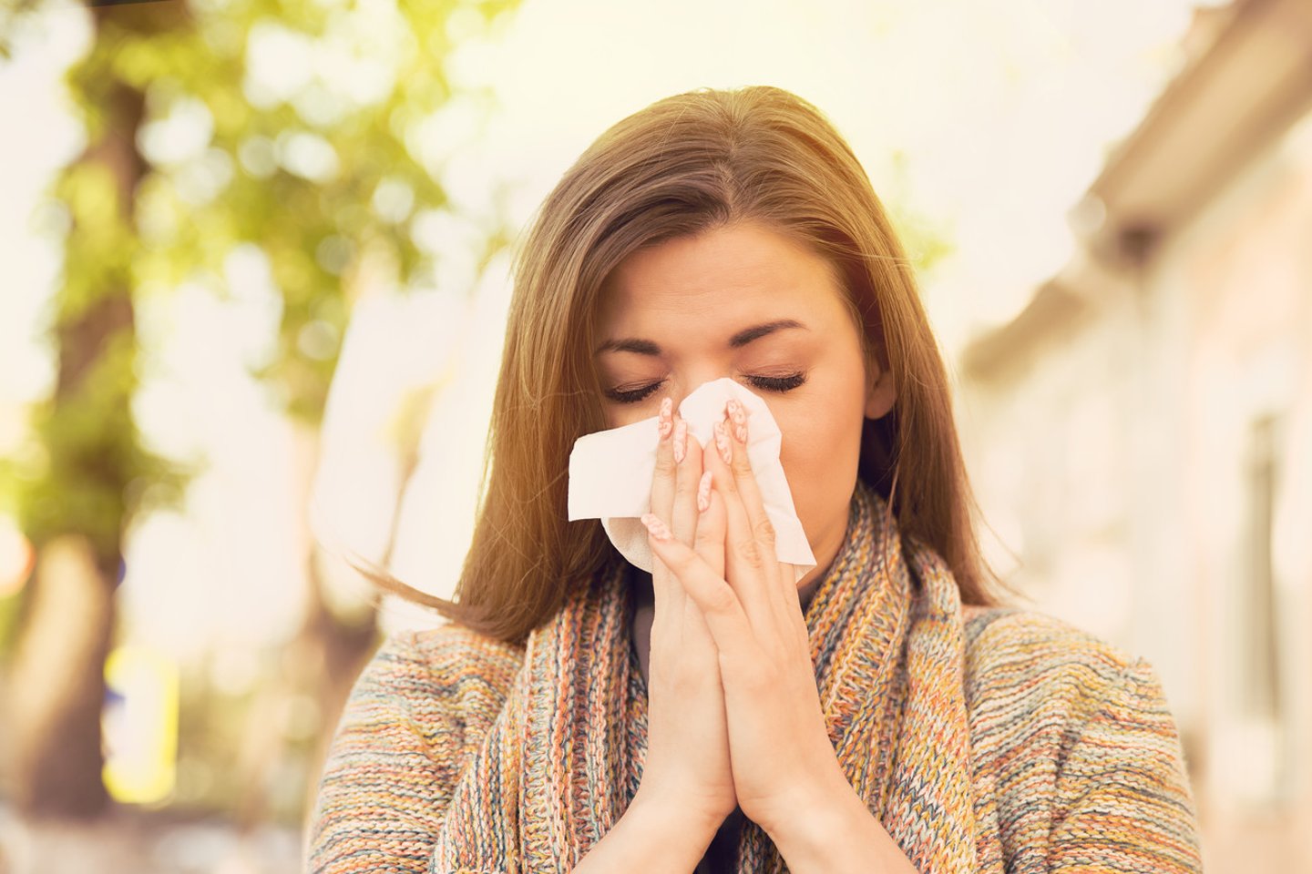 Woman with allergy symptoms blowing nose; Shutterstock ID 670193734