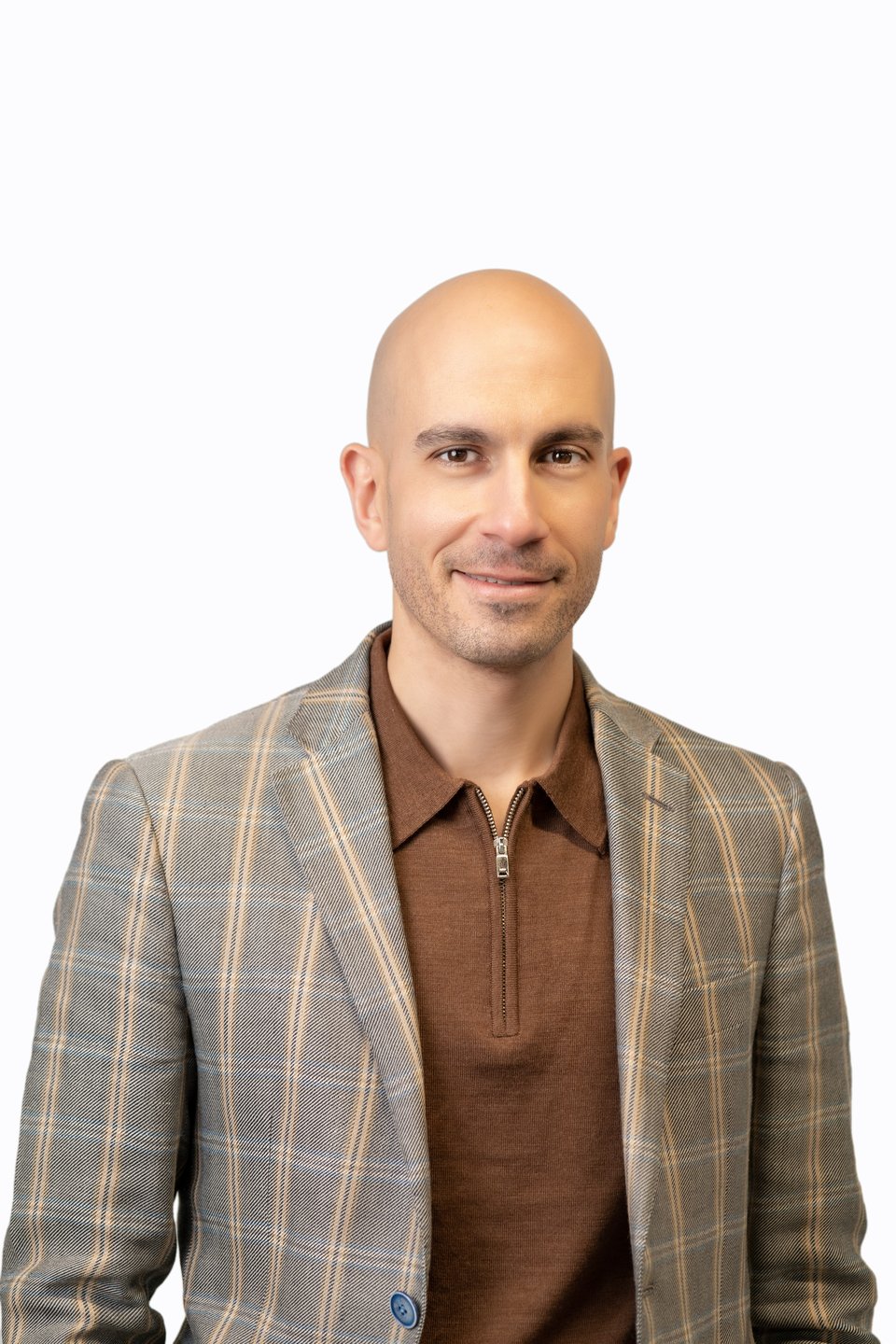 a man wearing a suit and tie smiling at the camera