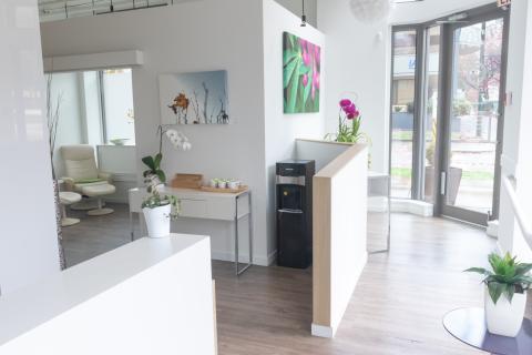 a living room filled with furniture and vase of flowers on a table