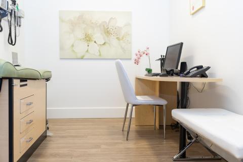 a bedroom with a bed and desk in a room