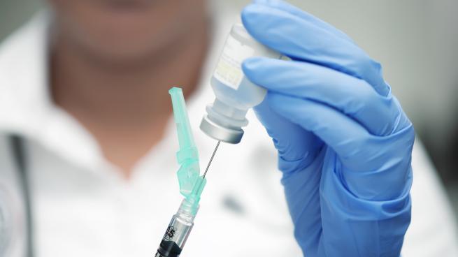 a hand holding a blue toothbrush