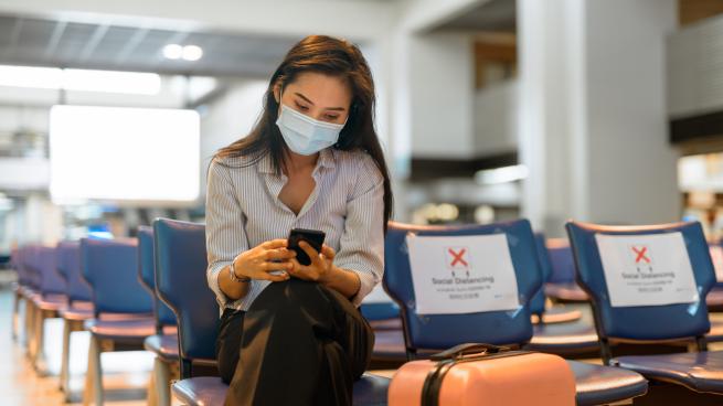 a person sitting in a chair talking on the phone