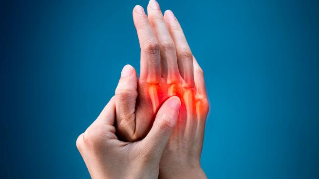 closeup of woman’s hands with red highlighting pain